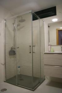 a shower with a glass door in a bathroom at Casa de Busto in Zas