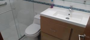 a bathroom with a white toilet and a sink at Perfecto Apartamento en el Mejor Sector in Cúcuta