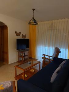 uma sala de estar com um sofá e uma televisão em Aguamarina, cerca de todo em La Antilla