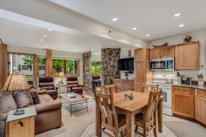 a kitchen and living room with a table and chairs at Laurelwood Condominiums 408 in Snowmass Village
