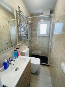 a bathroom with a sink and a shower and a toilet at Barca 5 NEW BEACH APARTMENT in Barcelona