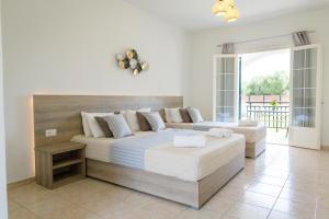 Ένα ή περισσότερα κρεβάτια σε δωμάτιο στο Tropical Apartments