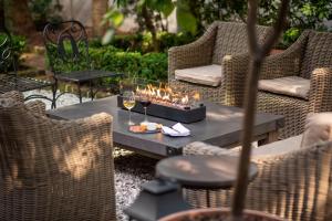 a table with glasses of wine and candles on it at Zero George Hotel in Charleston