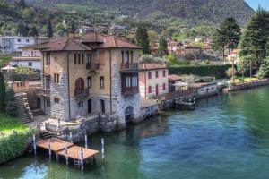 a building sitting on the water in a river at Villa Cecilia - pieds dans l'eau in Sulzano