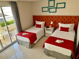 Cama ou camas em um quarto em Doral Guarujá