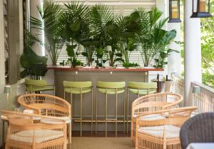 a bar with chairs and plants on a porch at Zero George Hotel in Charleston