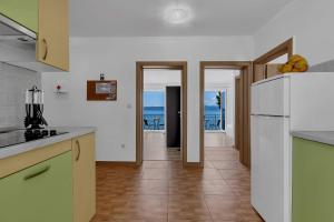 a kitchen with a refrigerator and a view of the ocean at View Blue Apartments in Brela