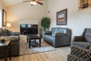 a living room with two couches and a tv at Cozy Quiet two story home pool outdoor entertaining bbq in Chandler