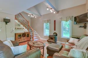 a living room with couches and a staircase at Game Room and Hot Tub Old Forge Home! in Old Forge