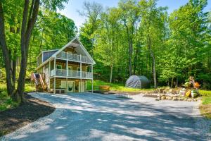 a house in the woods with a tent at Game Room and Hot Tub Old Forge Home! in Old Forge