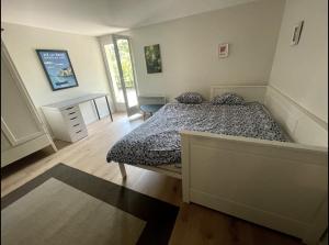 a bedroom with a bed and a desk in it at Quiet Studio in a House in Sevrier Annecy Lake very close to the lake in Sévrier