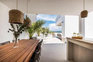 a dining room with a wooden table and chairs at Villa Corus in Murter