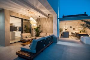 a living room with a blue couch and a table at Villa Corus in Murter