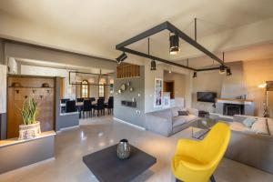 a living room with a couch and a yellow chair at Villa Elisabeth in Platamonas