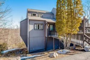 a small house with a fence and a tree at Pocono Paradise - 3 bedroom 3 and half bathroom townhouse in Tannersville