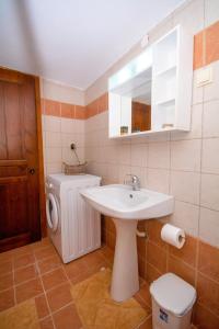 a bathroom with a sink and a toilet and a mirror at Christina Apartments in Kissamos