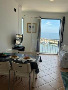 a dining room with a table and a view of the ocean at Albamare apartment in Marettimo