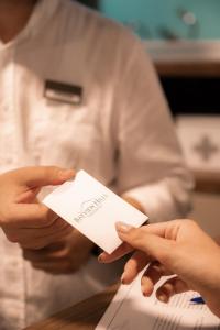 a chef holding a piece of paper in his hands at Bayview Hills Luxury Residences in Tivat