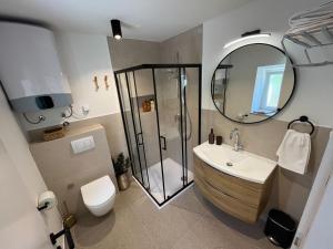 a bathroom with a shower and a sink and a toilet at Nona Vi - Boutique Stone House in Bol
