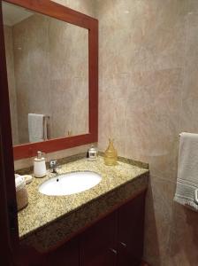 a bathroom with a sink and a mirror at Moradia, 4 quartos, a 200 metros da praia in Perafita