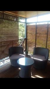 two chairs and a table in a room with a window at Chalet L in Saint-Pierre