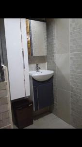 a bathroom with a sink and a mirror at Chalet L in Saint-Pierre