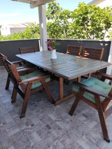 a wooden table and chairs on a patio at Apartments Lanterna Ražanac in Ražanac