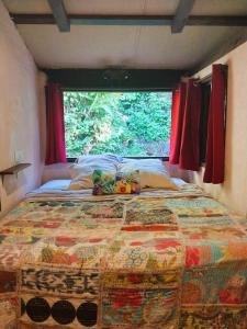 a bed in a room with a large window at Soul Rise in Taravao