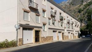 a large white building on the side of a street at Balcón de La Iruela I in La Iruela