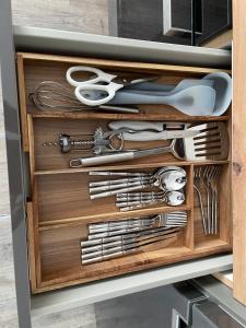 a drawer full of utensils in a cabinet at Ferienwohnung in Hünfeld