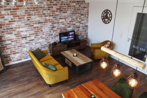 a living room with furniture and a brick wall at dock one - Grömitz in Grömitz