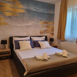 a bedroom with a bed with two towels on it at Apartments Miočić in Zadar