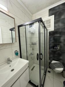 a bathroom with a shower and a sink at Yalcinkayalar Aparthotel in Datca