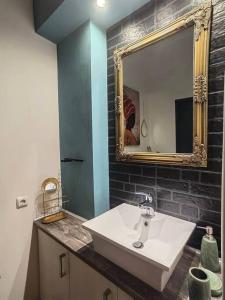 a bathroom with a sink and a mirror at The Cozy Nest in Rhodes town in Rhodes Town