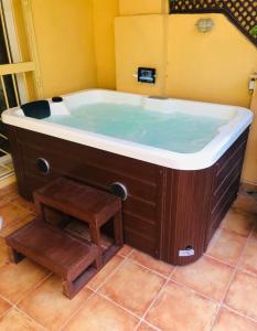 a large bath tub with a stool in a bathroom at Residencial Bajo con jardín y jacuzzi privado Calahonda Royale in Cabopino