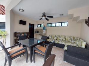a living room with a table and a couch at Villas Cozumel #7 in Cozumel +9 photos