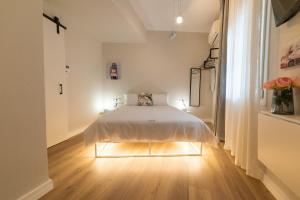 a white bedroom with a bed in a room at MeYia studios in Thessaloniki