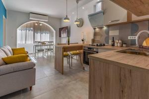 a kitchen and living room with a couch and a table at New two bedroom apartment Maloni in Pula