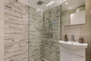 a bathroom with a sink and a glass shower at New two bedroom apartment Maloni in Pula +19 photos