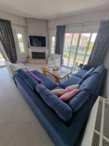 a large blue couch in a living room at Vlasis home in Nafpaktos