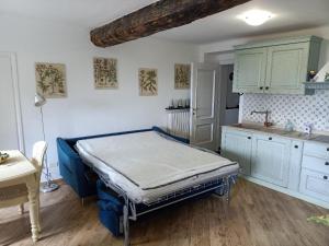 a room with a bed in a kitchen with a counter at Casetta Jacaranda in Genoa