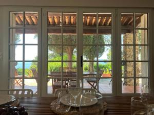 a dining room with large sliding glass doors at Les Stoechades in Rayol-Canadel-sur-Mer