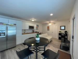 a kitchen and living room with a table and a couch at Guest houses West Palm Beach 2BR or 1BR in West Palm Beach