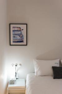 a bedroom with a bed and a picture of a car on the wall at MeYia studios in Thessaloniki