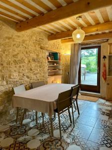 a dining room with a table and chairs at La Source in Rustrel