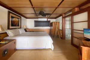 a bedroom with a bed and a ceiling fan at Kuhio Shores 316 in Koloa