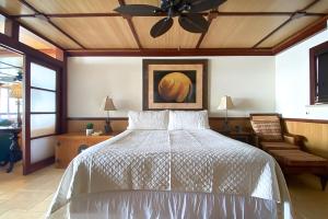 a bedroom with a bed and a ceiling fan at Kuhio Shores 316 in Koloa
