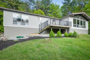 a house with a porch and a balcony at Gilford Vacation Rental with Lake Access and Mtn Views in Gilford