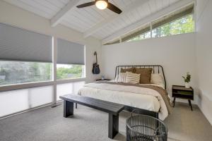 a bedroom with a bed and a table and windows at Gilford Vacation Rental with Lake Access and Mtn Views in Gilford
