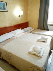 Postel nebo postele na pokoji v ubytování Hotel Ferrari